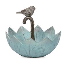 a bird sitting on top of a metal flower