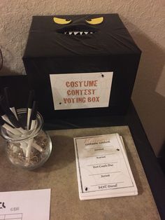 a halloween costume contest box with toothbrushes in it and other items on the counter