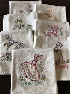 six embroidered towels with different designs on them