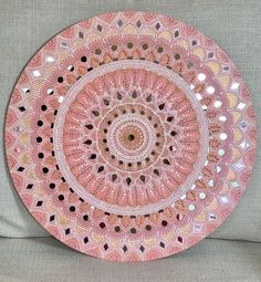 a pink plate sitting on top of a couch