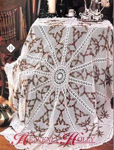 a crocheted table cloth on top of a wooden chair next to a candle