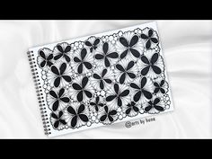 a notebook with black and white designs on it