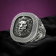 Discover the timeless elegance of our Lion Ring with Greek Ornament, crafted from high-quality 925 Sterling Silver. This stunning ring features a detailed lion motif, symbolizing strength and courage, surrounded by intricate Greek ornamental designs that add a touch of ancient elegance. Each piece is meticulously handmade, showcasing exceptional craftsmanship and attention to detail, ensuring every ring is unique and of the highest quality. Perfect for both men and women, this statement ring add Greek Ornament, Lion Ring, Viking Ring, Masonic Ring, Retro Ring, Animal Rings, Ancient Symbols, Handmade Rings, Gifts For Brother