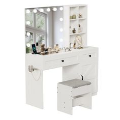 a white vanity table with lights and drawers