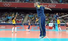 a group of people on a court playing volleyball