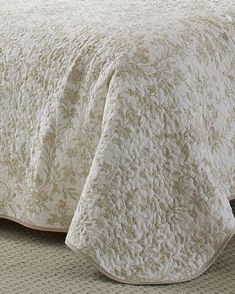 a bed with a white bedspread on top of it