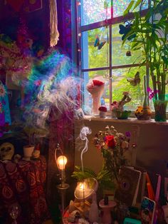 a room filled with lots of different types of items and plants in front of a window