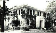 an old black and white photo of a building with ivy growing on it's sides