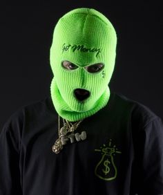 a person wearing a neon green mask and necklace