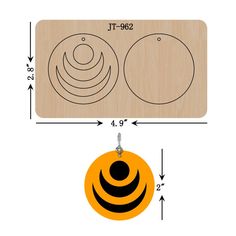 an orange and black circle with two smaller circles on it, next to a wooden plaque