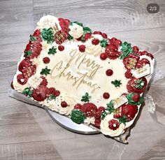 a birthday cake with frosting and berries on it sitting on top of a table