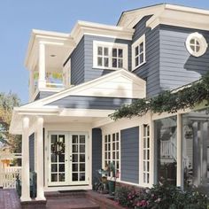 a blue house with white trim and windows