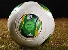 a soccer ball sitting on top of a lush green field