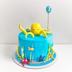 a blue cake with an octopus on top