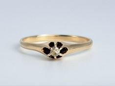 a yellow gold ring with black and white diamonds