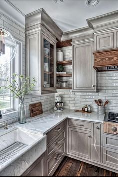 a kitchen with marble counter tops and wooden cabinets