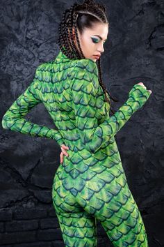 If you're looking for an exotic, tropical themed fit, the Basilisk Costume will get the job done. This piece is made from a high quality stretchy and breathable Lycra fabric, printed with exceptional graphics as alwayz. The design features a body con fit, padded shoulders, long sleeves with thumbholes, a mock neckline Basilisk Costume, Fitted Green Rash Guard, Stretch Long Sleeve Bodysuit With Graphic Print, Fitted Green Long Sleeve Rash Guard, Fitted Long Sleeve Green Rash Guard, Green Long Sleeve Stretch Rash Guard, Green Long Sleeve Stretch Unitard, Green Stretch Long Sleeve Rash Guard, Green Stretch Long Sleeve Unitard