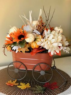 a wagon filled with flowers sitting on top of a table