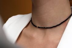 This is a very simple charming chocker that doesn't need an occasion.  Wear it to school, work, or any special date. This piece is perfect for elevating a minimalist look. Items Details  -Clasp :  Gold Plated on Brass Lobster Clasp -Chain Style : Black Onyx Round Glass Beads with a single Gold Plated Bead -Length : 35cm + 4.5cm Gold Plated on Brass Extension -Thickness: 2mm Free Shipping for orders CAD60 Please avoid chemical solutions, perfumes, excessive sweat, seawater and/or pool water. Salt water and chlorine can damage your jewelry. Chlorine can damage and discolor metals that are alloyed with the gold and can slowly erode the finish and polish of gemstones.Also, lotions and sprays create a film on the jewelry, making it dull and dingy. To keep any tarnish or wear from setting in, ta Black Necklaces, Black Choker Necklace, Semi Precious Beads, Pool Water, Necklace Gemstone, Black Necklace, Bead Necklace, Chain Styles, School Work