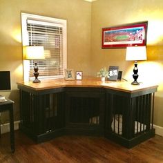 a corner desk in the corner of a room with two lamps on top of it