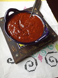 a bowl of chili sauce on a table