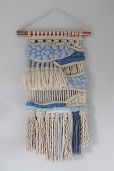 a wall hanging made out of macrame and yarn