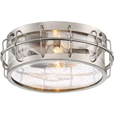 a flush light fixture with clear glass in an industrial style finish and metal cage design