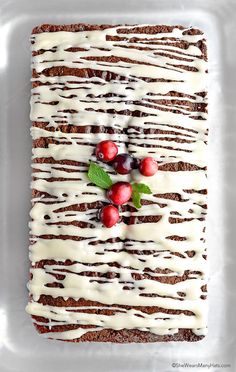 a piece of cake with icing and cherries on it