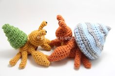 three crocheted stuffed animals sitting next to each other