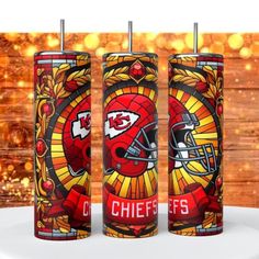 three red and yellow tumblers with the kansas chiefs logo on them, sitting next to each other