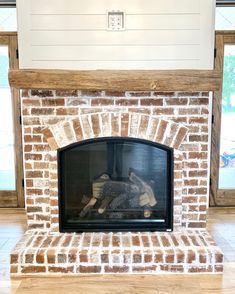 a brick fireplace with wood burning in it