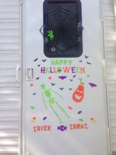 a white door decorated with halloween decorations and writing