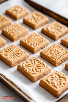 there are many square cookies on the baking sheet