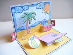 an open card with a beach scene and palm tree on the beach, it's made out of paper