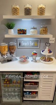 a snack bar with snacks and drinks on the counter in front of shelves filled with food