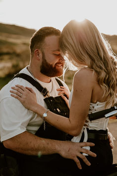 a man and woman are hugging each other