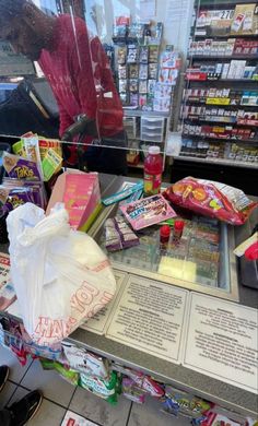 there is a display in the store with many items on it and one bag full of candy