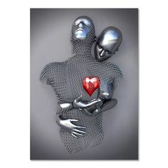 two metal figures holding a red heart in their arms