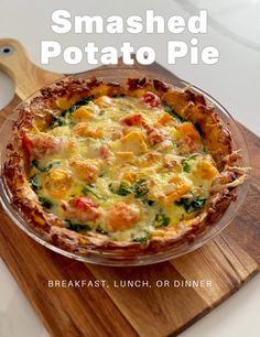 a baked potato pie sitting on top of a wooden cutting board