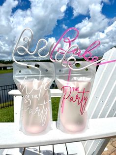 two pink glasses sitting on top of a white chair