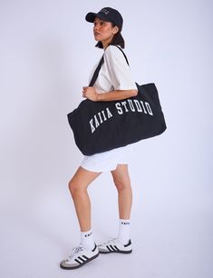 Introducing the ultimate stylish accessory - the Kaiia Studio Tote Bag in Black & White. Perfect for any occasion. this bag is both practical and fashionable. With its sleek design and versatile colour scheme. it will elevate any outfit. Don't miss out on this must-have tote! Fabric composition: 100% cotton Hand wash only MACC4016 Chic Black Canvas Bag With Removable Pouch, Trendy Black Weekend Bag, Chic Black Travel Bag With Removable Pouch, Black Shoulder Bag For Weekend, Trendy Black Shoulder Bag For Weekend, Chic Weekend Shoulder Bag With Adjustable Strap, Chic Shoulder Bag With Adjustable Strap For Weekend, Chic Large Capacity Black Travel Bag, Chic Weekend Shoulder Bag