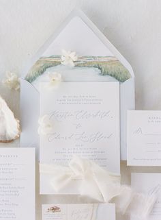 the wedding stationery is laid out on top of each other