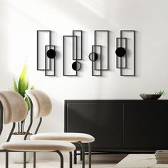 a room with chairs, tables and vases on the wall next to each other