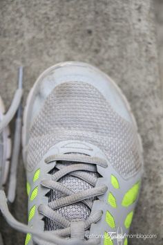 the bottom view of a tennis shoe with yellow laces