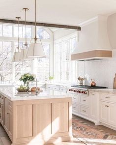 a kitchen with white cabinets and an island in the middle of the room is shown