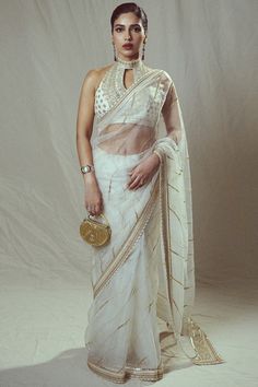 Gopi Vaid features a mesmerizing White Saree Set that captivates with its elegance. The eye-catching saree is crafted in organza with hand and machine embroidery. for weddings, sangeet, or engagement ceremonies. #Perniaspopupshop #womenswear #ethnic #whatiworewastrending #ppuslove #sareeset #weddingwear #organza #handembroidery #tussar #festivewear #engagement #sareeforwomen #printedsaree #weddingwear #sangeet #engagement Bhoomi Pednekar, Gopi Vaid, Halter Neck Blouse, Bhumi Pednekar, Halter Neck Blouses, Bridal Lehenga Red, White Saree, Embroidered Saree, Organza Saree