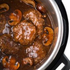 meatballs and mushrooms are cooking in the slow cooker