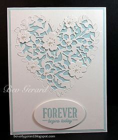 a heart shaped card with flowers on it