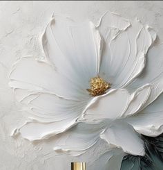 a large white flower sitting on top of a table