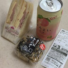 an open can of soda and some food on a table